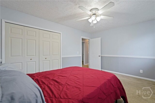 75 Brown Thrasher Ct, Richmond Hill, GA 31324 - bedroom featuring a textured ceiling, a closet, carpet flooring, and ceiling fan