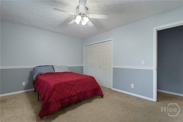 75 Brown Thrasher Ct, Richmond Hill, GA 31324 - carpeted bedroom featuring a textured ceiling, a closet, and ceiling fan