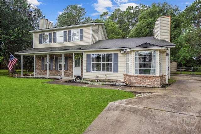 75 Brown Thrasher Ct, Richmond Hill, GA 31324 - view of front facade featuring a chimney, a front lawn, and a porch
