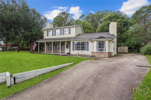 75 Brown Thrasher Ct, Richmond Hill, GA 31324 - view of front of property featuring a chimney, a porch, and concrete driveway