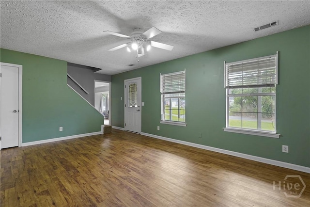 75 Brown Thrasher Ct, Richmond Hill, GA 31324 - unfurnished living room with ceiling fan, a textured ceiling, and wood finished floors