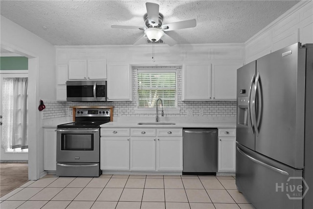 75 Brown Thrasher Ct, Richmond Hill, GA 31324 - kitchen with stainless steel appliances, light countertops, white cabinetry, ceiling fan, and a textured ceiling
