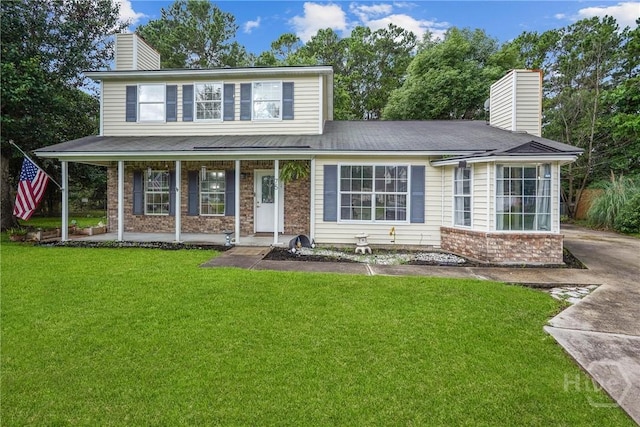 75 Brown Thrasher Ct, Richmond Hill, GA 31324 - view of front of property featuring a chimney, a front yard, a porch, and brick siding