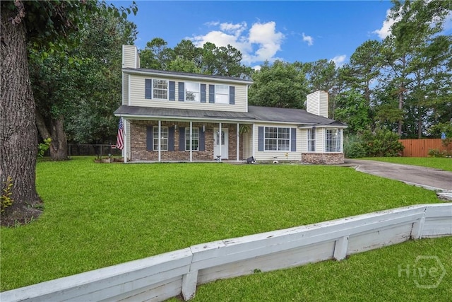 75 Brown Thrasher Ct, Richmond Hill, GA 31324 - traditional-style home featuring a chimney, covered porch, and concrete driveway