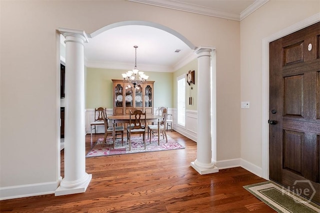 144 Sweetwater Cir, Rincon, GA 31326 - dining room featuring arched walkways, decorative columns, wood finished floors, ornamental molding, and a chandelier
