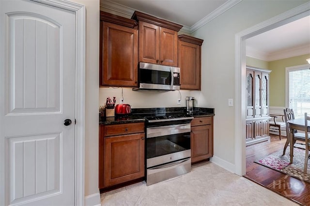 144 Sweetwater Cir, Rincon, GA 31326 - kitchen featuring appliances with stainless steel finishes, ornamental molding, brown cabinets, and dark stone counters