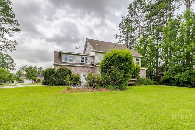 144 Sweetwater Cir, Rincon, GA 31326 - view of side of property featuring a lawn