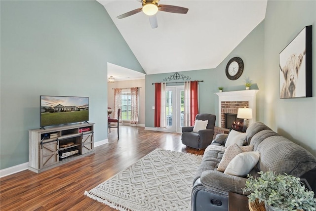 112 Kingsley Dr N, Guyton, GA 31312 - living area with high vaulted ceiling, ceiling fan, a brick fireplace, and wood finished floors