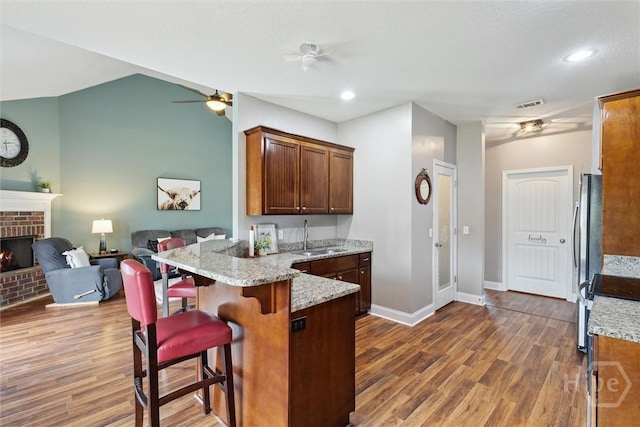 112 Kingsley Dr N, Guyton, GA 31312 - kitchen featuring a ceiling fan, dark wood-style floors, a peninsula, light stone counters, and recessed lighting