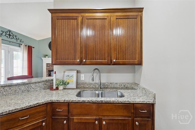 112 Kingsley Dr N, Guyton, GA 31312 - kitchen with light stone counters and brown cabinetry