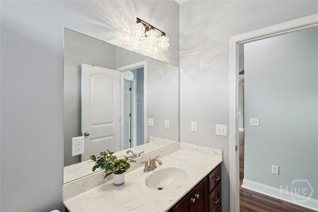 112 Kingsley Dr N, Guyton, GA 31312 - bathroom with vanity, wood finished floors, and a chandelier