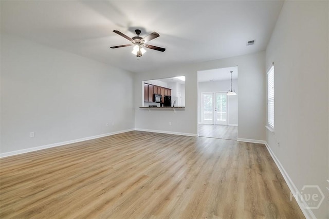 7 Hartland Ct, Savannah, GA 31407 - unfurnished living room featuring light wood-type flooring, french doors, and a ceiling fan