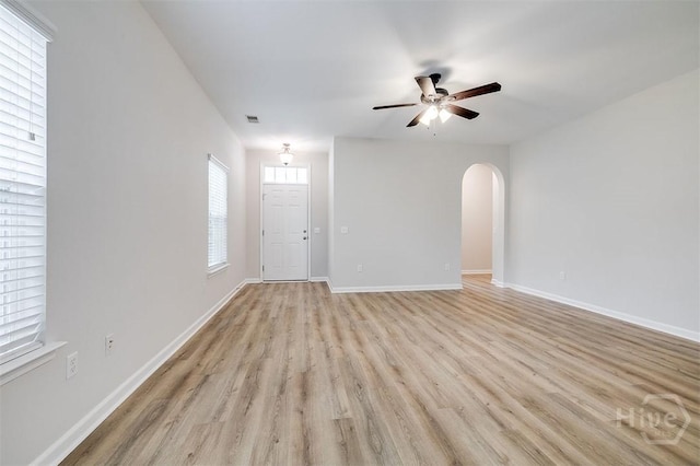 7 Hartland Ct, Savannah, GA 31407 - unfurnished living room with light wood finished floors, arched walkways, and a ceiling fan