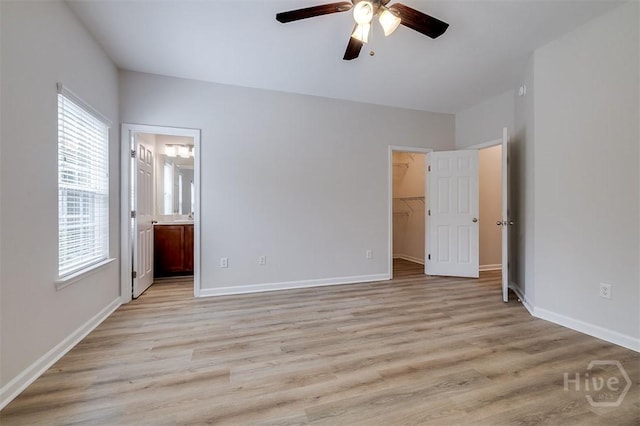 7 Hartland Ct, Savannah, GA 31407 - unfurnished bedroom featuring multiple windows, a spacious closet, and light wood-style floors
