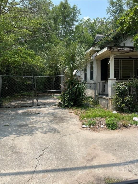 2119 Harden St, Savannah, GA 31415 - view of side of property with a gate and stucco siding