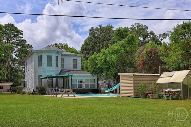 206 Bonaventure Rd, Thunderbolt, GA 31404 - back of house featuring an outdoor structure, an exterior structure, and a lawn
