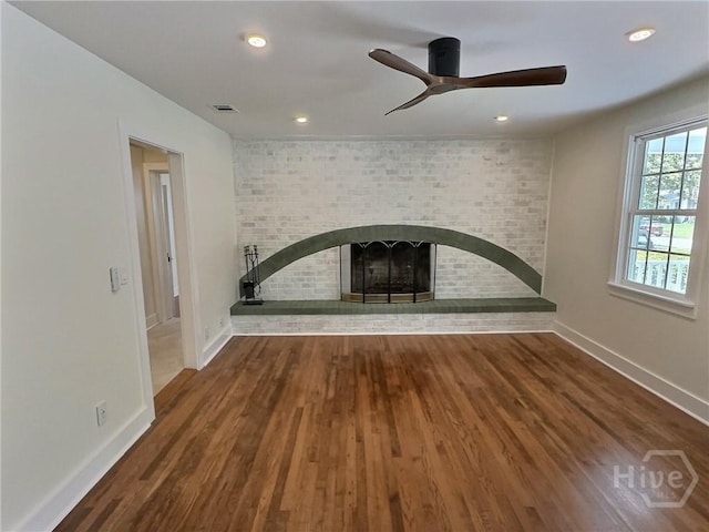 417 E 65th St, Savannah, GA 31405 - unfurnished living room featuring ceiling fan, wood finished floors, a fireplace, recessed lighting, and brick wall