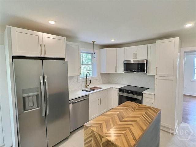 417 E 65th St, Savannah, GA 31405 - kitchen with stainless steel appliances, white cabinets, light countertops, backsplash, and recessed lighting