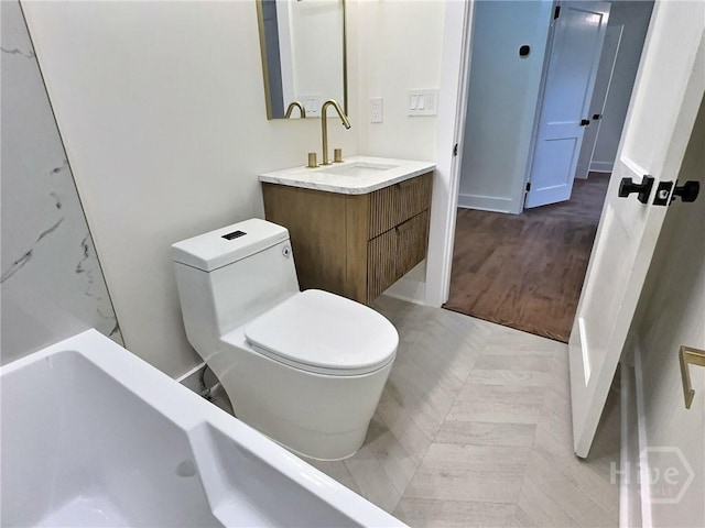 417 E 65th St, Savannah, GA 31405 - bathroom featuring vanity, a bath, and wood finished floors