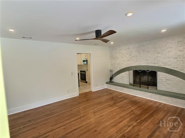 417 E 65th St, Savannah, GA 31405 - unfurnished living room with a ceiling fan, a brick fireplace, wood finished floors, and recessed lighting