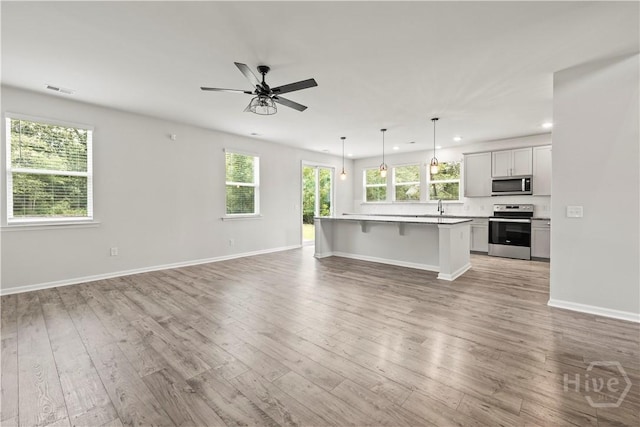 136 Ramsey Way, Rincon, GA 31326 - unfurnished living room with light wood-style flooring, recessed lighting, and a ceiling fan
