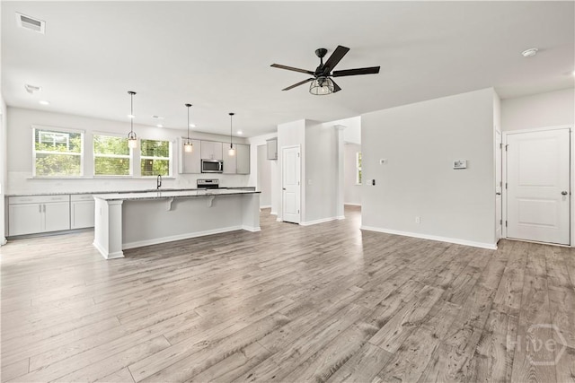 136 Ramsey Way, Rincon, GA 31326 - unfurnished living room with light wood-style flooring, ceiling fan, and recessed lighting
