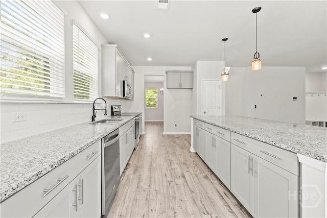 136 Ramsey Way, Rincon, GA 31326 - kitchen featuring stainless steel appliances, decorative backsplash, light wood-style floors, light stone countertops, and recessed lighting