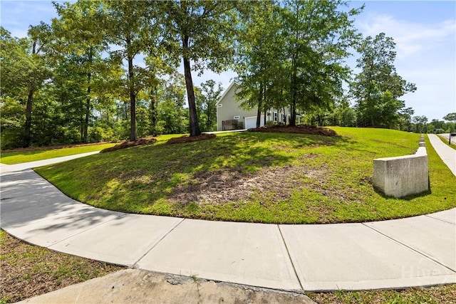 136 Ramsey Way, Rincon, GA 31326 - view of green lawn featuring a garage
