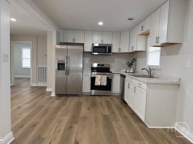 12 Jaguar Ln, Savannah, GA 31419 - kitchen featuring stainless steel appliances, white cabinetry, light wood-style flooring, and recessed lighting