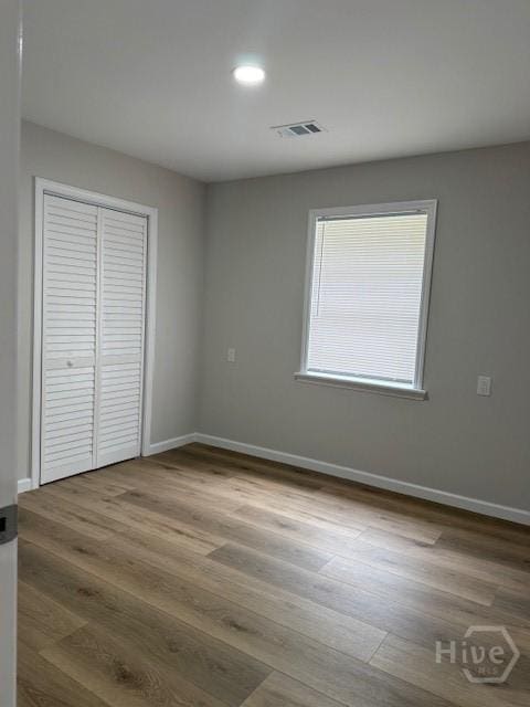 12 Jaguar Ln, Savannah, GA 31419 - unfurnished bedroom with wood finished floors, a closet, and recessed lighting