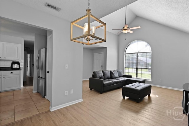 807 Hidden Hollow Cir, Hinesville, GA 31313 - living room with a ceiling fan, light wood finished floors, a textured ceiling, and high vaulted ceiling