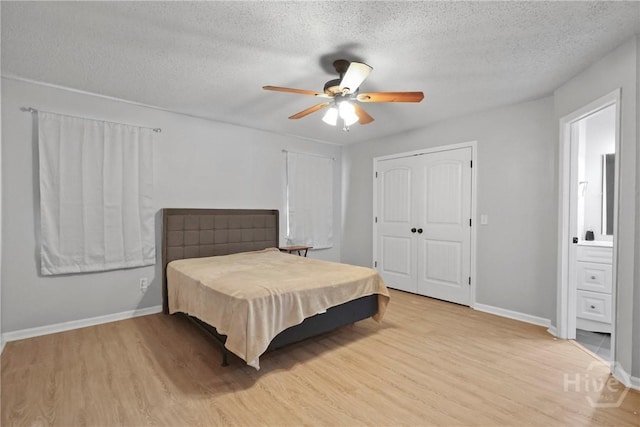 807 Hidden Hollow Cir, Hinesville, GA 31313 - bedroom featuring light wood-style floors, a textured ceiling, ceiling fan, and a closet