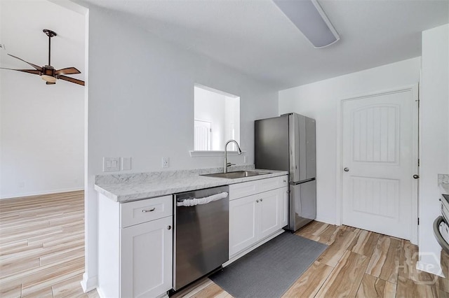140 Abigail Cir, Ellabell, GA 31308 - kitchen featuring stainless steel appliances, light wood-style floors, white cabinetry, and ceiling fan