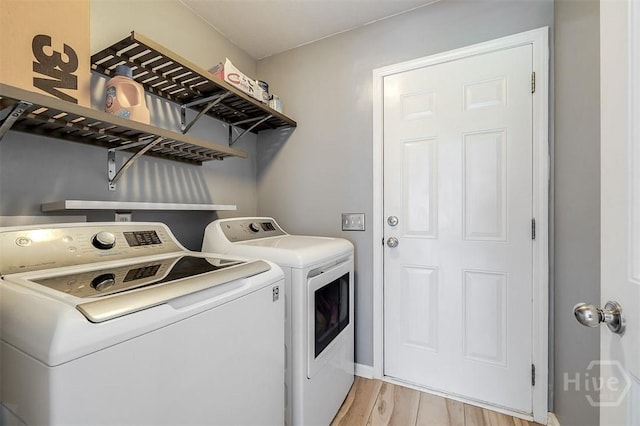 140 Abigail Cir, Ellabell, GA 31308 - laundry room with washer and clothes dryer and light wood-type flooring