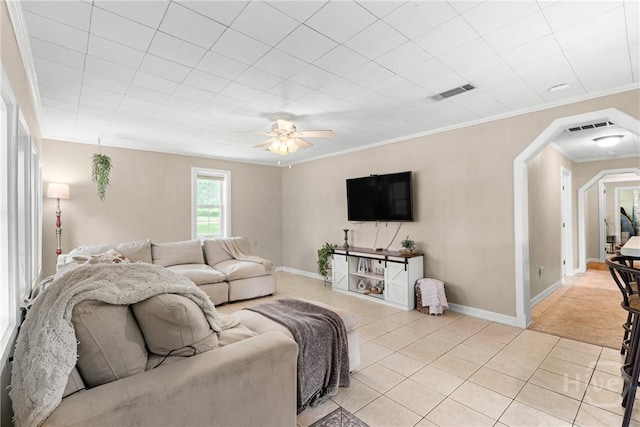 1072 Burtons Ferry Highway, Sylvania, GA 30467 - living area with light tile patterned floors, a ceiling fan, ornamental molding, and arched walkways