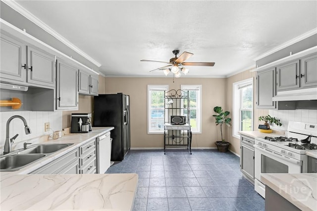1072 Burtons Ferry Highway, Sylvania, GA 30467 - kitchen featuring white appliances, under cabinet range hood, a ceiling fan, tasteful backsplash, and gray cabinetry