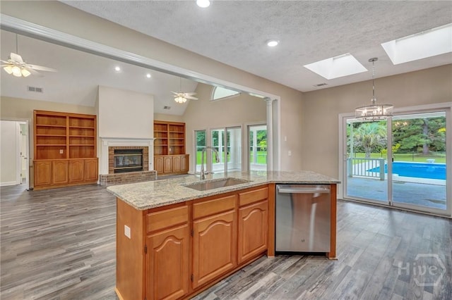 600 Old Louisville Rd, Guyton, GA 31312 - kitchen with stainless steel dishwasher, a skylight, light wood finished floors, a textured ceiling, and lofted ceiling