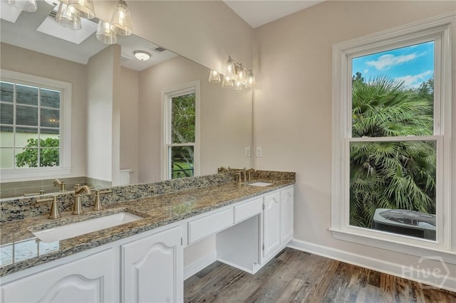 600 Old Louisville Rd, Guyton, GA 31312 - bathroom featuring double vanity, wood finished floors, and a chandelier
