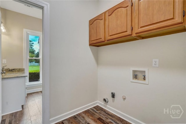 600 Old Louisville Rd, Guyton, GA 31312 - laundry area featuring hookup for a gas dryer, dark wood-type flooring, washer hookup, and cabinet space