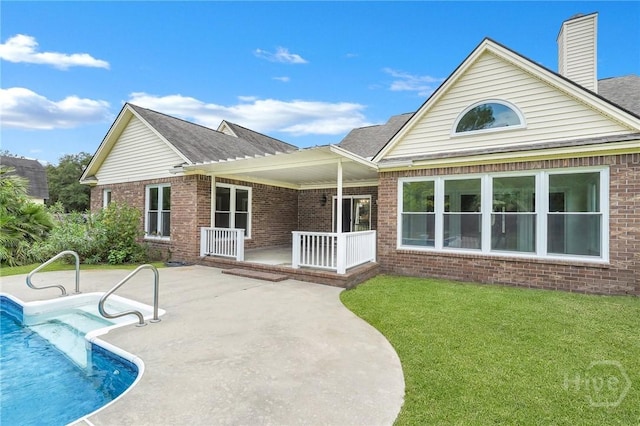 600 Old Louisville Rd, Guyton, GA 31312 - back of property featuring brick siding, a lawn, covered porch, an outdoor pool, and a patio