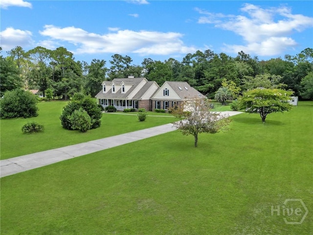 600 Old Louisville Rd, Guyton, GA 31312 - new england style home featuring concrete driveway, a front lawn, and a chimney