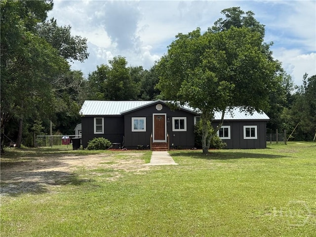 3052 Effingham Hwy, Sylvania, GA 30467 - single story home with a front lawn, board and batten siding, and a metal roof