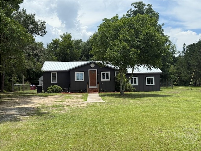 3052 Effingham Hwy, Sylvania, GA 30467 - view of front of home with board and batten siding, a front lawn, and a metal roof
