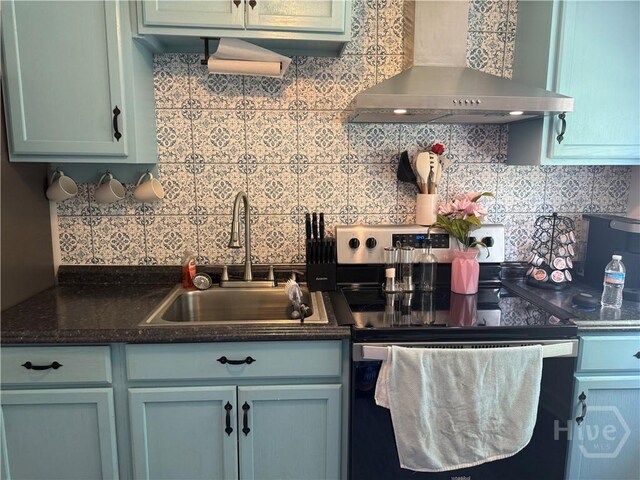 3052 Effingham Hwy, Sylvania, GA 30467 - kitchen with wall chimney range hood, stainless steel range with electric stovetop, and tasteful backsplash