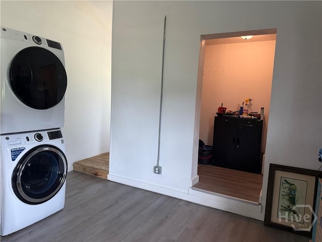 3052 Effingham Hwy, Sylvania, GA 30467 - washroom featuring stacked washer and clothes dryer and wood finished floors