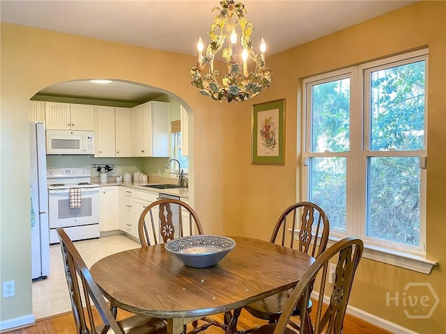 606 Dancy Ave, Savannah, GA 31419 - dining room with arched walkways and a chandelier