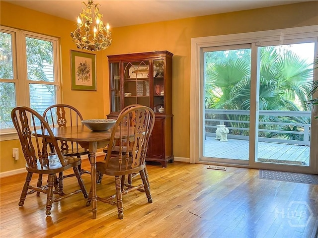 606 Dancy Ave, Savannah, GA 31419 - dining room with light wood-style floors and a chandelier