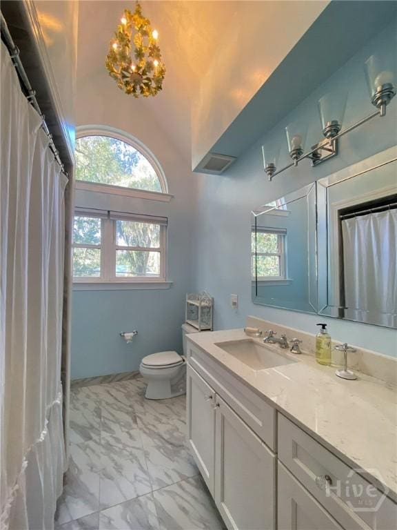 606 Dancy Ave, Savannah, GA 31419 - bathroom featuring marble look tiles, vanity, healthy amount of natural light, a chandelier, and vaulted ceiling