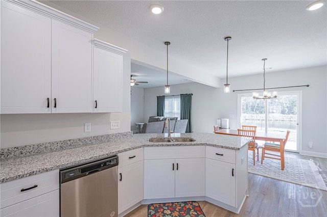 194 Gavin Way, Rincon, GA 31326 - kitchen with dishwasher, light wood-type flooring, a peninsula, a chandelier, and white cabinets