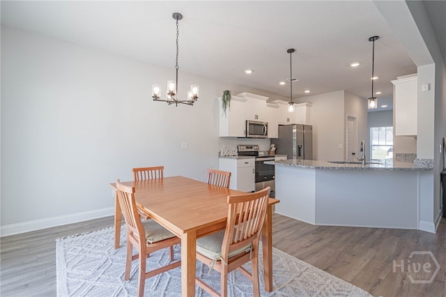 194 Gavin Way, Rincon, GA 31326 - dining area with light wood-style floors, a chandelier, and recessed lighting